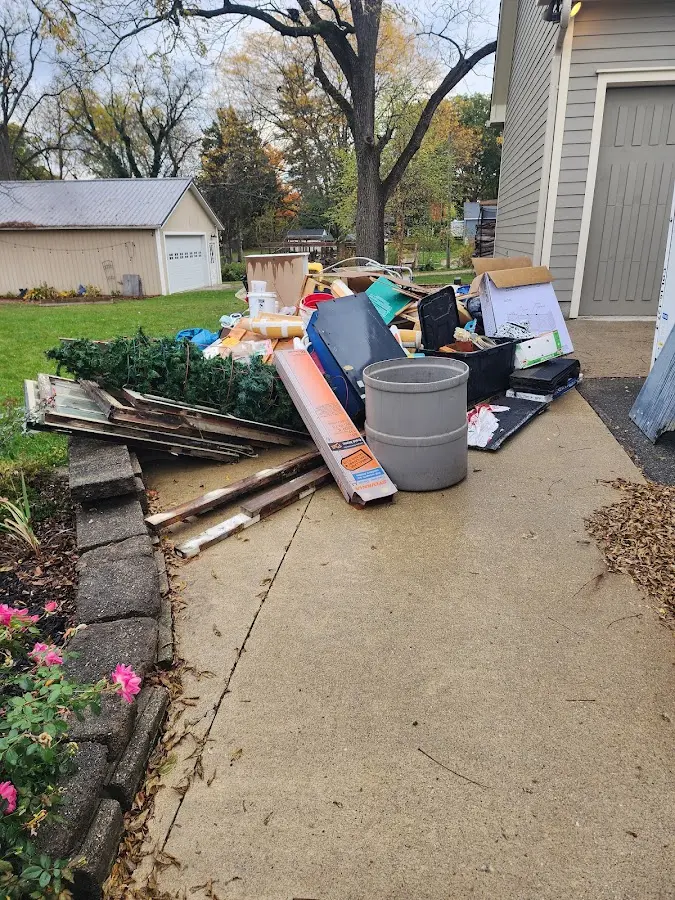 Dumpster being loaded with debris for Roofing Dumpster Rental in Sharon